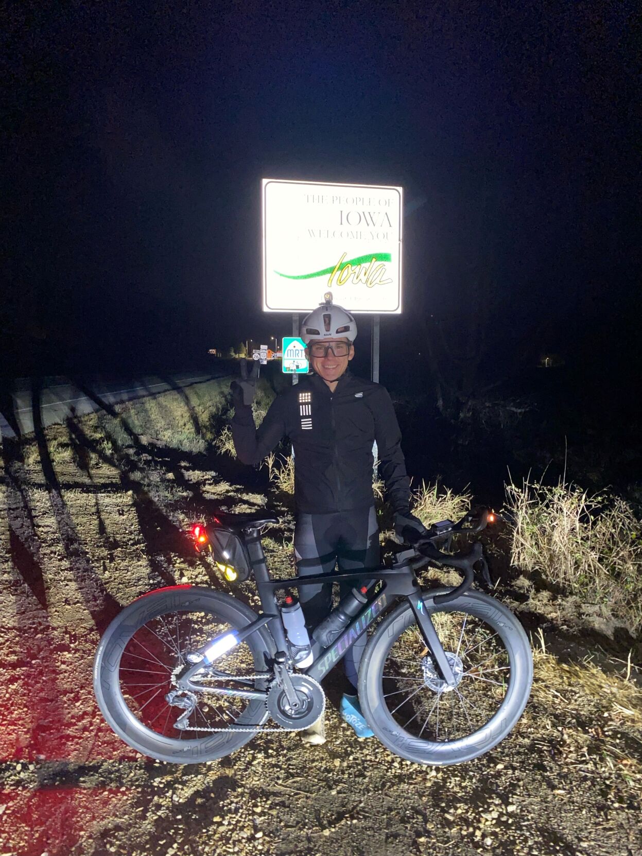 Chase Wark at the Welcome to Iowa sign